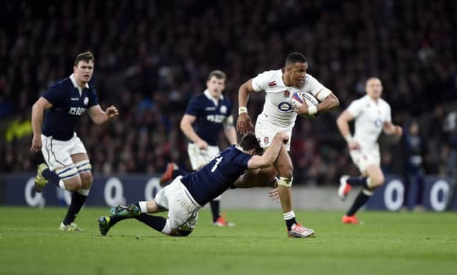 England's Anthony Watson gets away from a tackle by Tommy Seymour. Picture: PA
