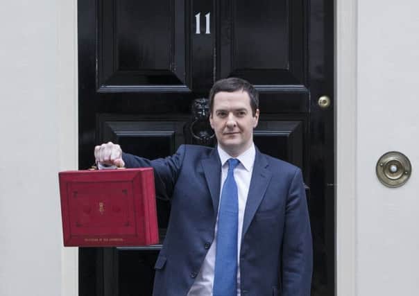 George Osborne outside No 11 with the celebrated Red Box. Picture: Getty