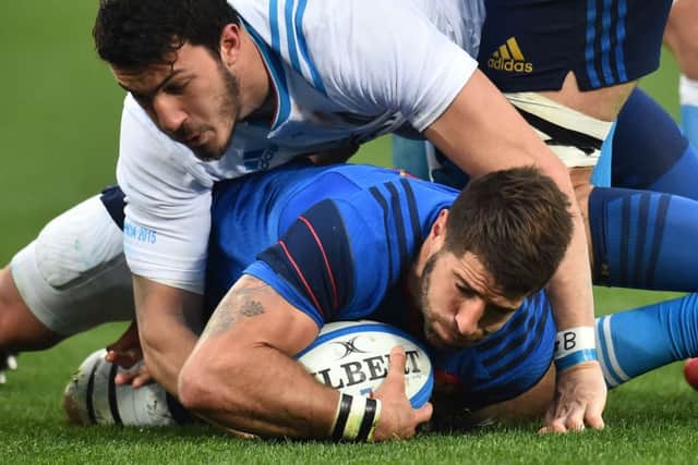 French scrum-half Sebastien Tillous Borde is tackled by Italy winger Leonardo Sarto. Picture: Getty