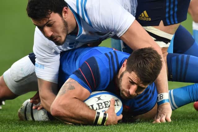 French scrum-half Sebastien Tillous Borde is tackled by Italy winger Leonardo Sarto. Picture: Getty