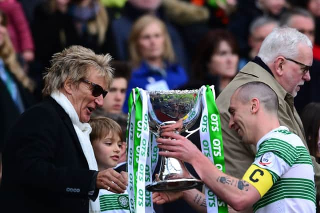 Scott Brown is presented with the League Cup trophy by life long Celtic fan Rod Stewart. Picture: Getty