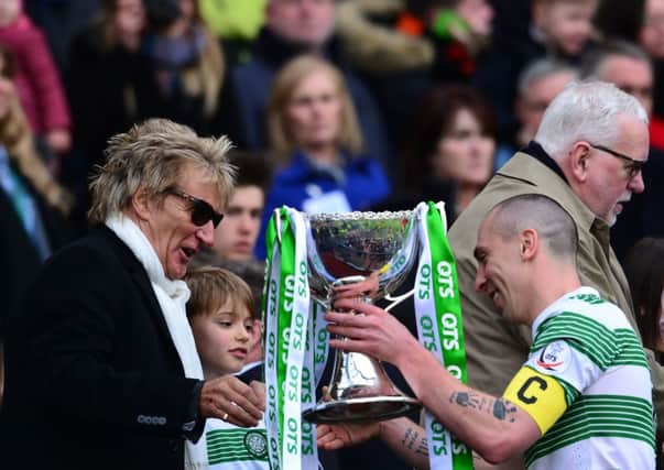 Scott Brown is presented with the League Cup trophy by life long Celtic fan Rod Stewart. Picture: Getty
