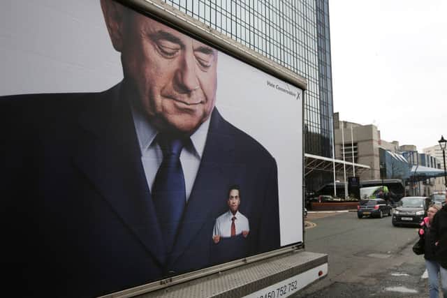 A Conservative party poster depicting Ed Miliband in the pocket of former Scottish First Minister Alex Salmond. Picture: Getty