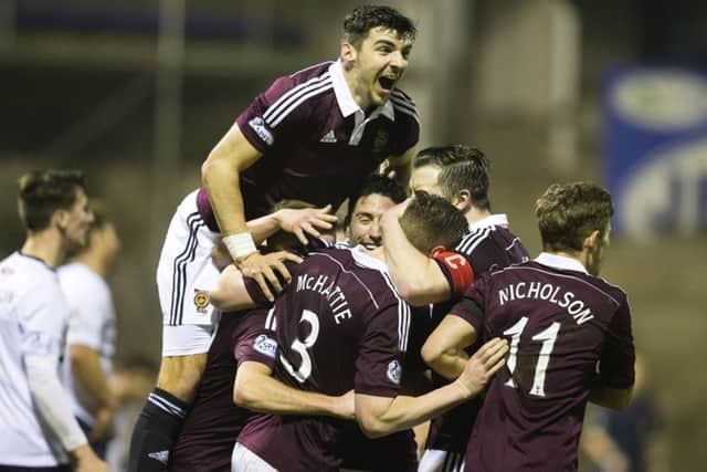 Hearts players surround Kevin McHattie after he opens the scoring in Kirkcaldy. Picture: SNS