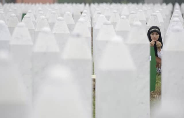 A woman prays at a memorial centre for the Bosnian dead near Srebrenica. Picture: AP