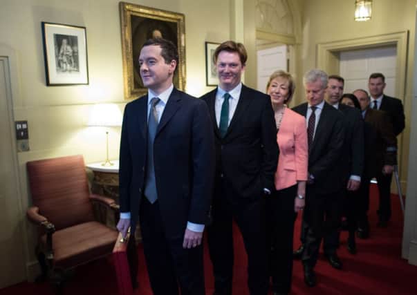 Chancellor of the Exchequer George Osborne stands with Chief Secretary to the Treasury Danny Alexander and the rest of his treasury team. Picture: Getty