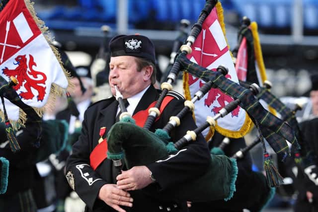 Pipe Major John Simpson leads his pipe band at Edinburgh Castle. Picture: Colin Hattersley