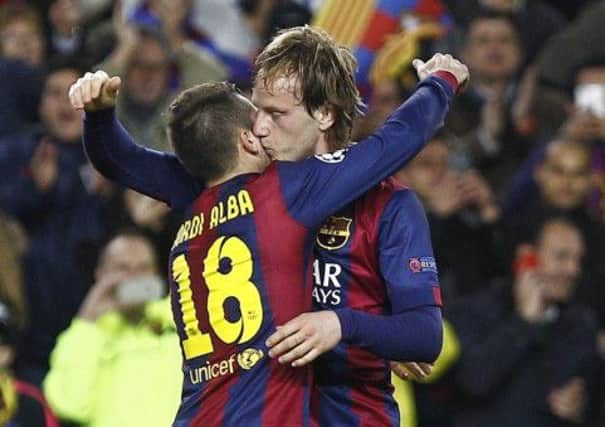 Barcelona's Croatian midfielder Ivan Rakitic, right, and Barcelona defender Jordi Alba celebrate. Picture: Getty