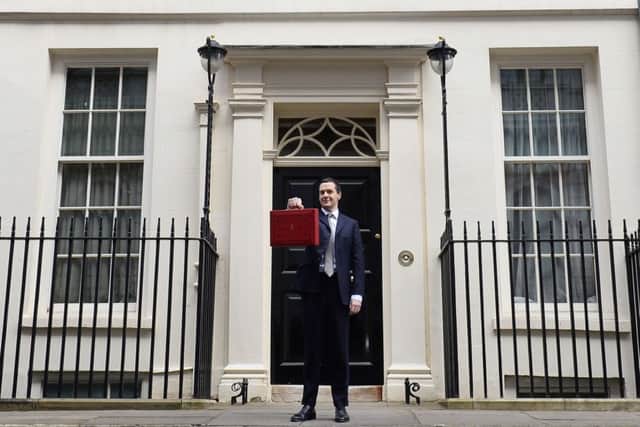 Osborne poses for pictures with the Budget box as he leaves 11 Downing Street. Picture: AFP/Getty