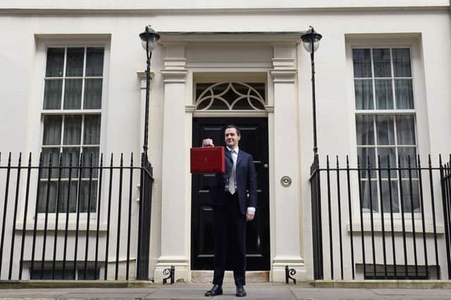 Osborne poses for pictures with the Budget box as he leaves 11 Downing Street. Picture: AFP/Getty