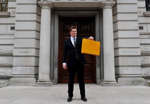 Alexander at the Treasury with his yellow Budget box. Picture: PA