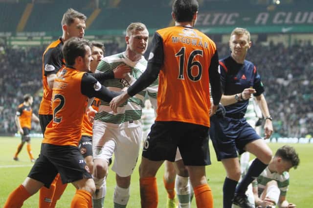 Celtic's John Guidetti confronts Dundee United's Ryan McGowan. Picture: SNS