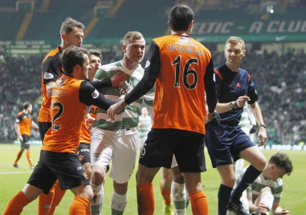 Celtic's John Guidetti confronts Dundee United's Ryan McGowan. Picture: SNS