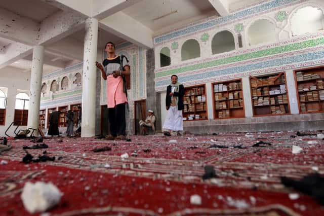 Yemenis inspect the damage after the bombing at the Badr mosque in southern Sanaa. Picture: Getty