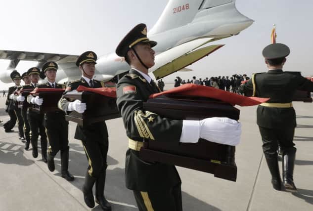 As relations improve Chinese soldiers repatriate the bodies of troops killed in the Korean war. Picture: Getty