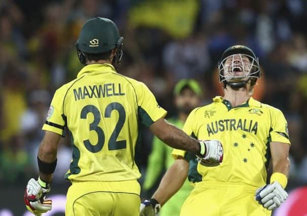 Shane Watson celebrates with Glenn Maxwell after the Australians sealed victory in Adelaide. Picture: Getty