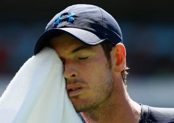A dejected Andy Murray wipes away the sweat during his defeat by Novak Djokovic. Picture: Getty