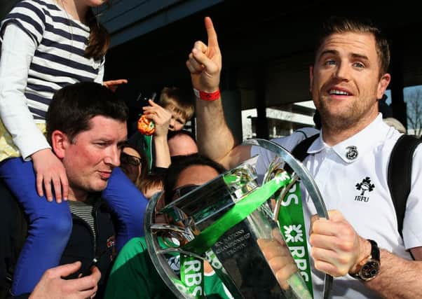 Ireland No 8 Jamie Heaslip shows off the Six Nations trophy to supporters at Dublin airport. Picture: PA