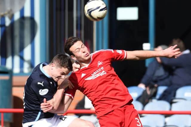 Dundees Stephen McGinn, left, battles for the ball with Andrew Considine. Picture: SNS