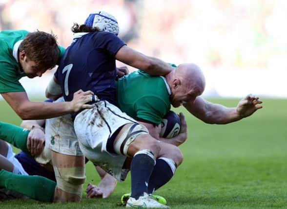 Irelands inspirational captain Paul OConnell, right, is tackled by Blair Cowan. Picture: AP