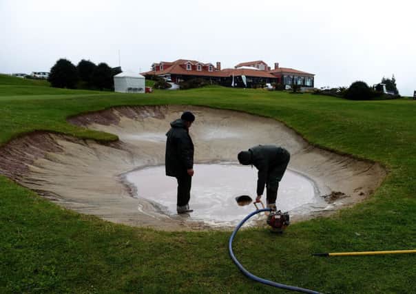 Greens staff pump water out of a bunker at the Madeira Islands Open. Picture: Getty