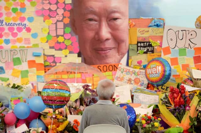 Visitors take selfies and souvenir photographs in an area set aside for tributes to Lee Kuan Yew. Picture: Getty