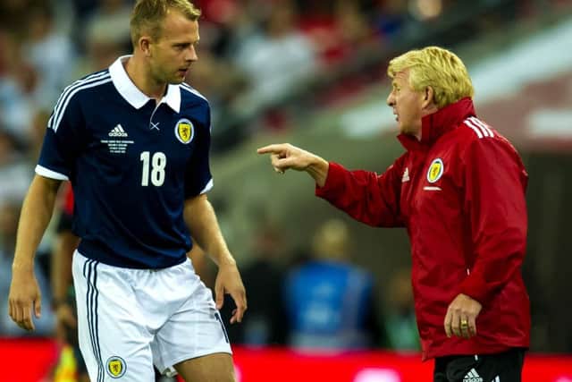 Gordon Strachan passes on instructions to Jordan Rhodes during his appearance against England. Picture: SNS