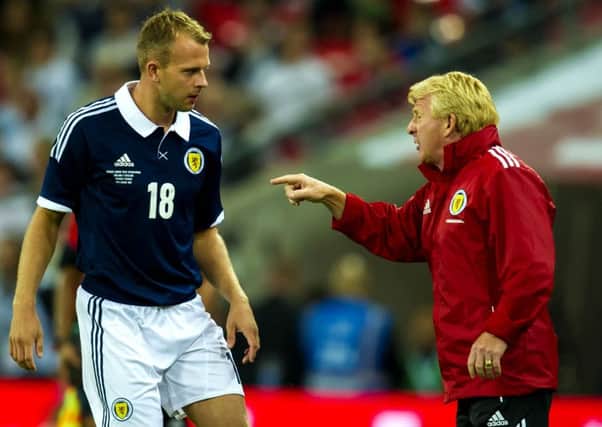 Gordon Strachan passes on instructions to Jordan Rhodes during his appearance against England. Picture: SNS