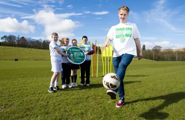 Celtic winger Gary MackaySteven is joined by Lennoxtown Primary pupils. Picture: SNS