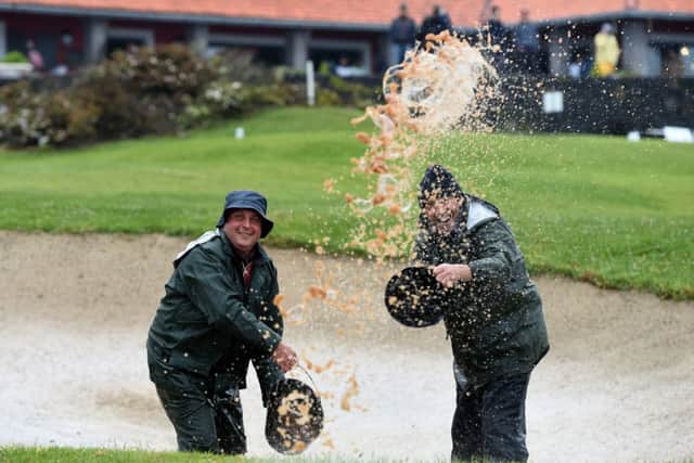 Green keepers bale the water out of a bunker at Madeira Islands Open. Picture: Getty