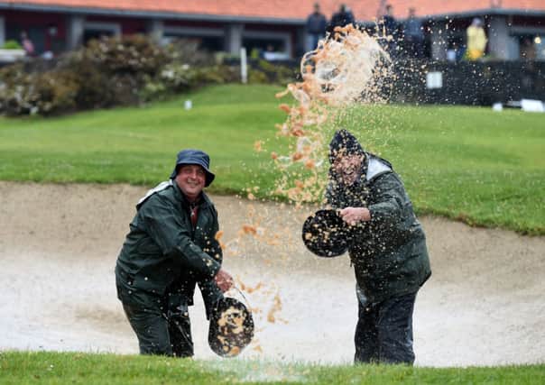 Green keepers bale the water out of a bunker at Madeira Islands Open. Picture: Getty