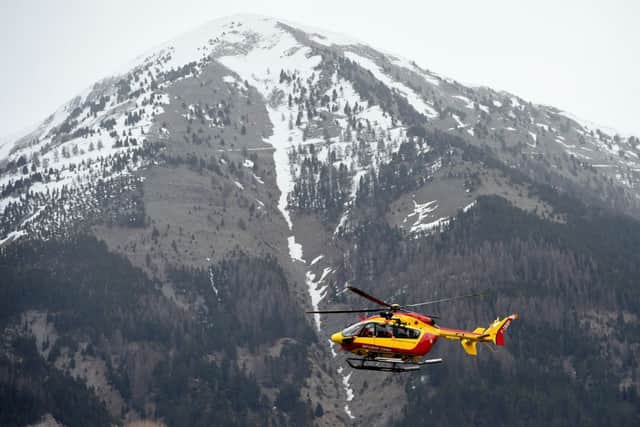 A rescue helicopter seen near the crash site. Picture: AFP