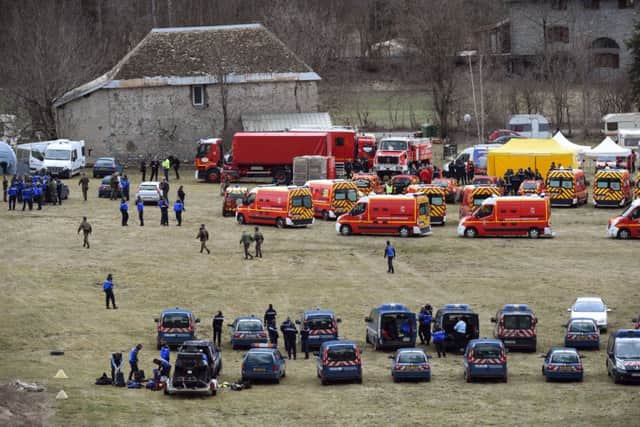 Emergency services (back) and members of the French gendarmerie gather in Seyne. Picture: AFP