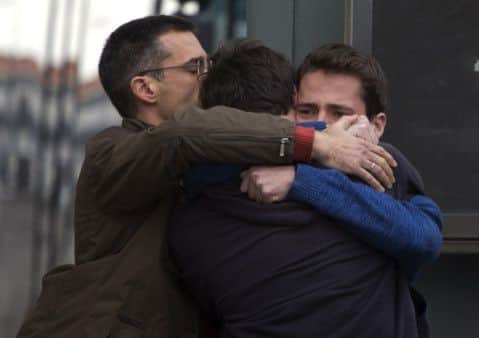 People comfort each other at Barcelona-El Prat airport. Picture: AP