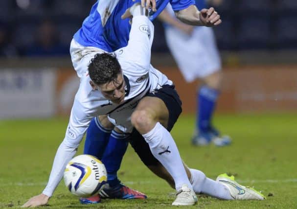 Raiths Ross Callachan holds off Queens Michael Paton at Starks Park. Picture: SNS