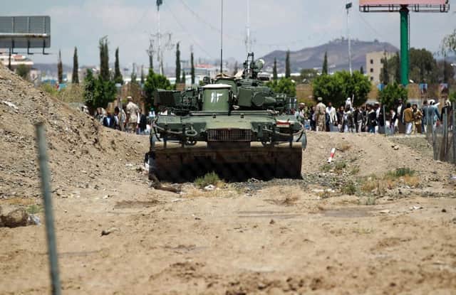 A tank stands outside the presidential palace as the Shiite Houthi militia guards it. Picture: AFP/Getty