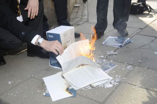The Penrose Inquiry report is burned by people affected by the NHS mistake. Picture: Greg Macvean
