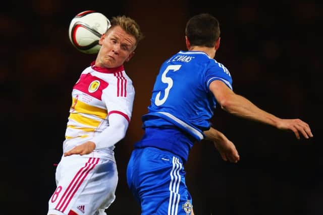 Matt Ritchie jumps with Jonny Evans during his Scotland debut. Picture: Getty