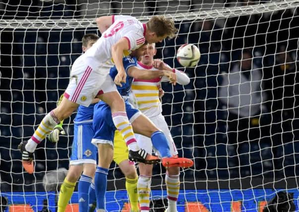 Christophe Berra heads the ball home to open the scoring late on for Scotland. Picture: SNS