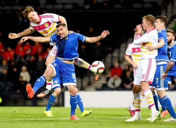 Christophe Berra rises above Northern Ireland's Aaron Hughes to head the winning goal. Picture: SNS