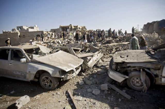 People search for survivors under houses destroyed by Saudi airstrikes near Sanaa Airport yesterday. Picture: AP