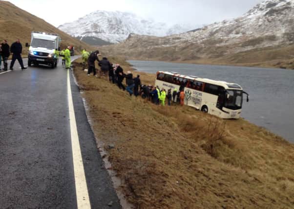 Pasengers are led off the coach after it crashed at the Rest and Be Thankfull in Argyll. Picture: Stuart Herd