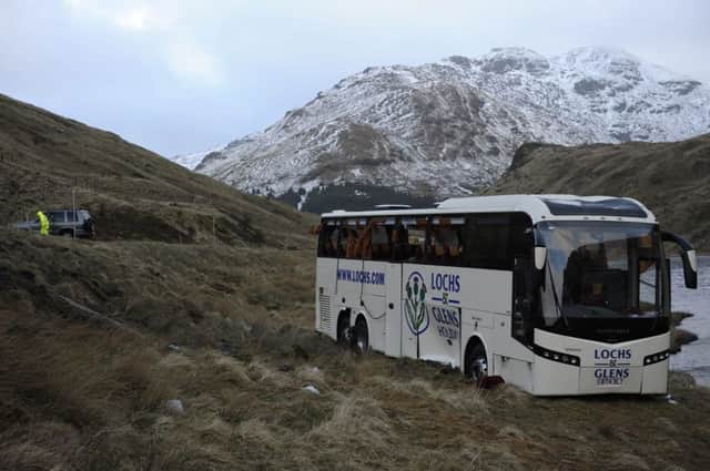 The coach almost toppled into Loch Restil after wind blew it off the A83. Picture: Hemedia