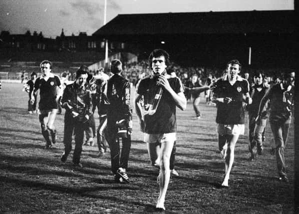 Frank Liddell leads the Hearts players lap of honour after his goal sealed the title in 1980. Picture: TSPL