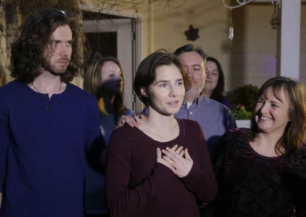 Amanda Knox, centre, stands with her mother, Edda Mellas, right, and her fiance, Colin Sutherland, left. Picture: AP