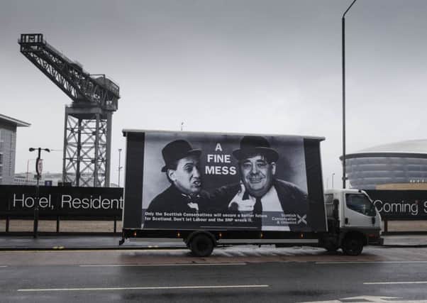 A vehicle carrying a poster designed by the Conservative Party makes fun of Labour's Ed Miliband and former first minister Alex Salmond. Picture: PA