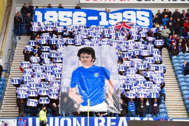 Rangers fan display a banner in tribute to Davie Cooper. Picture: SNS