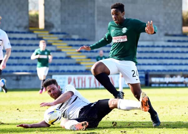 Hibernian's Dominique Malonga battles for the ball with Craig Barr. Picture: SNS
