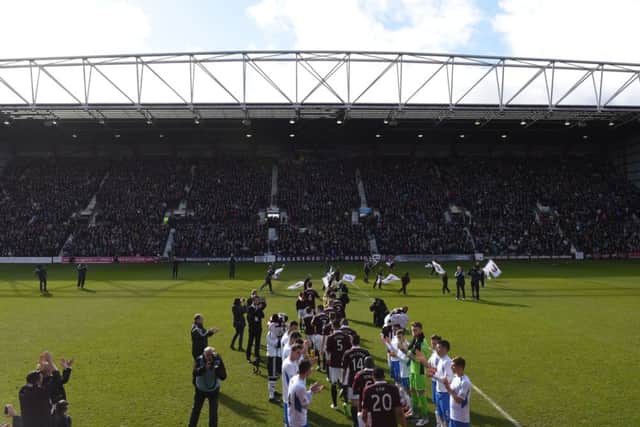 The Queen of the South players form a guard of honour for recently-crowned Championship champions Hearts. Picture: SNS