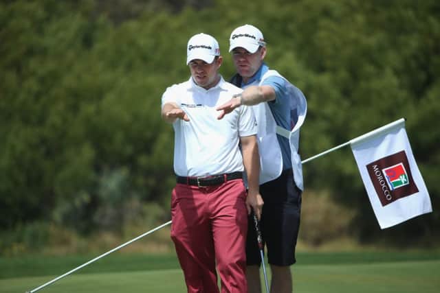 Richie Ramsay and his caddie line up a putt on the fourth hole at Golf du Palais Royal. Picture: Getty
